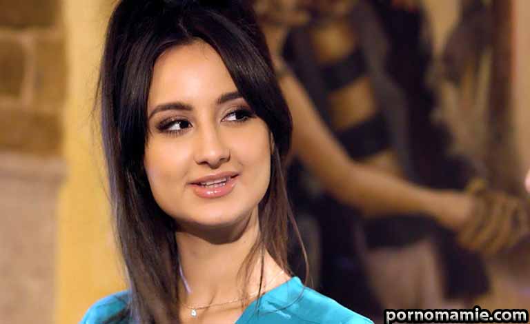 Romantic true love meme: Top Signs You Found A Woman of Noble Character Woman with long dark hair wearing a turquoise top, looking to her left with a gentle smile at an event.